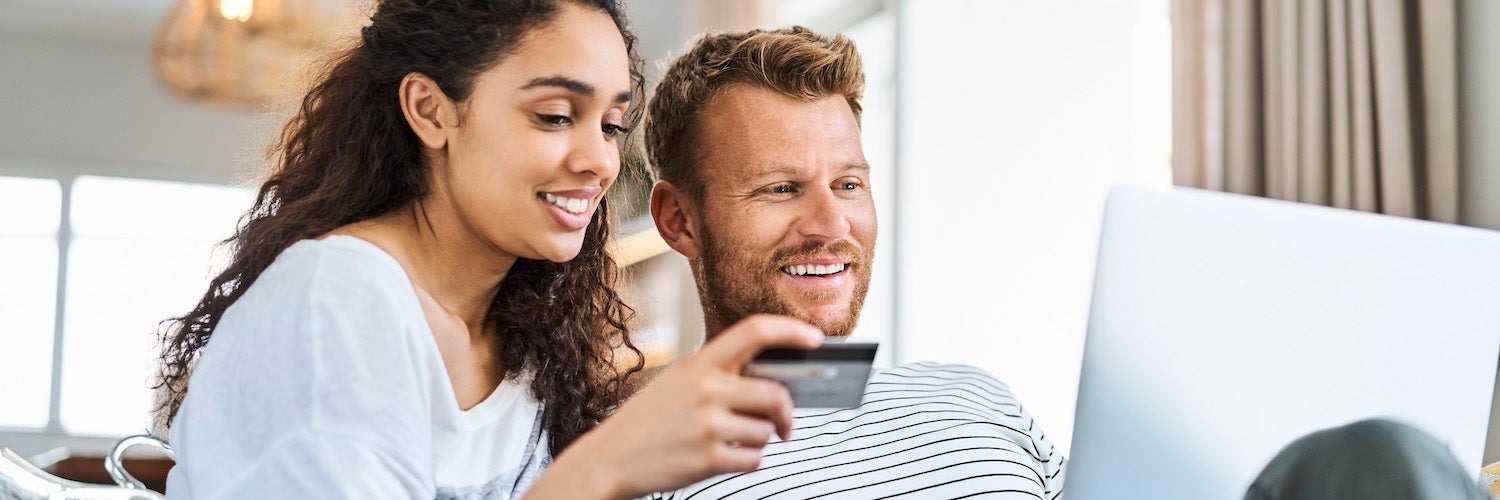 Man and woman looking at credit card