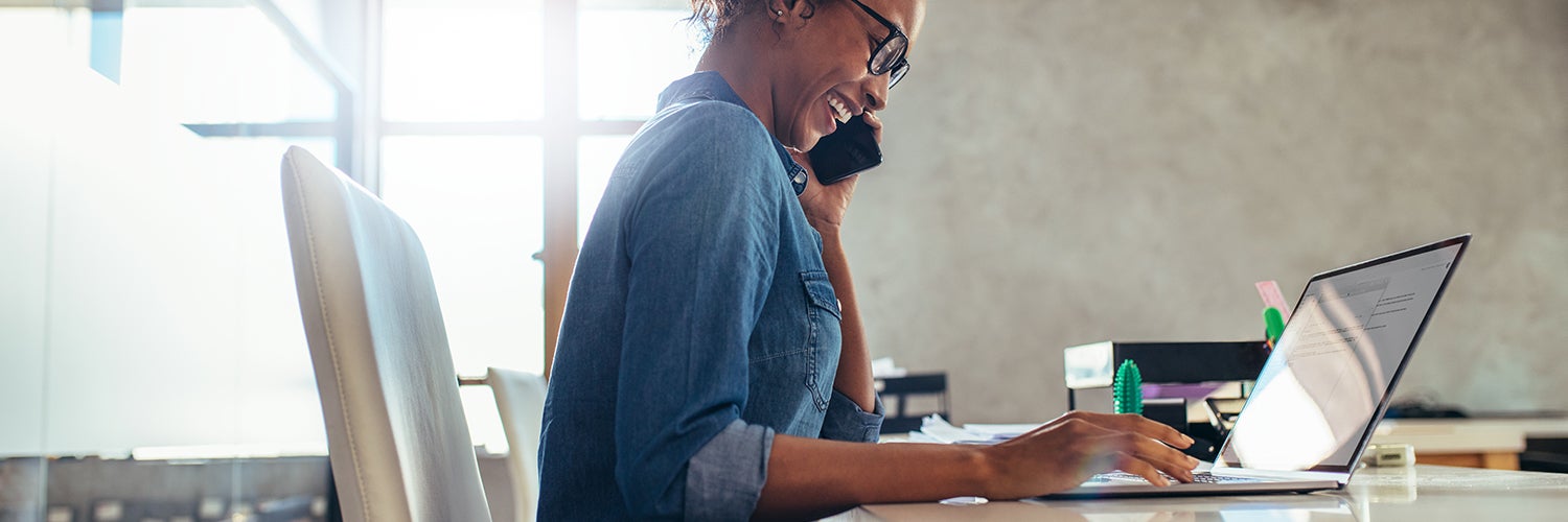 A millennial woman working at her computer.