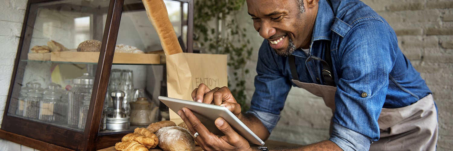 Man using tablet for managing business at bakehouse