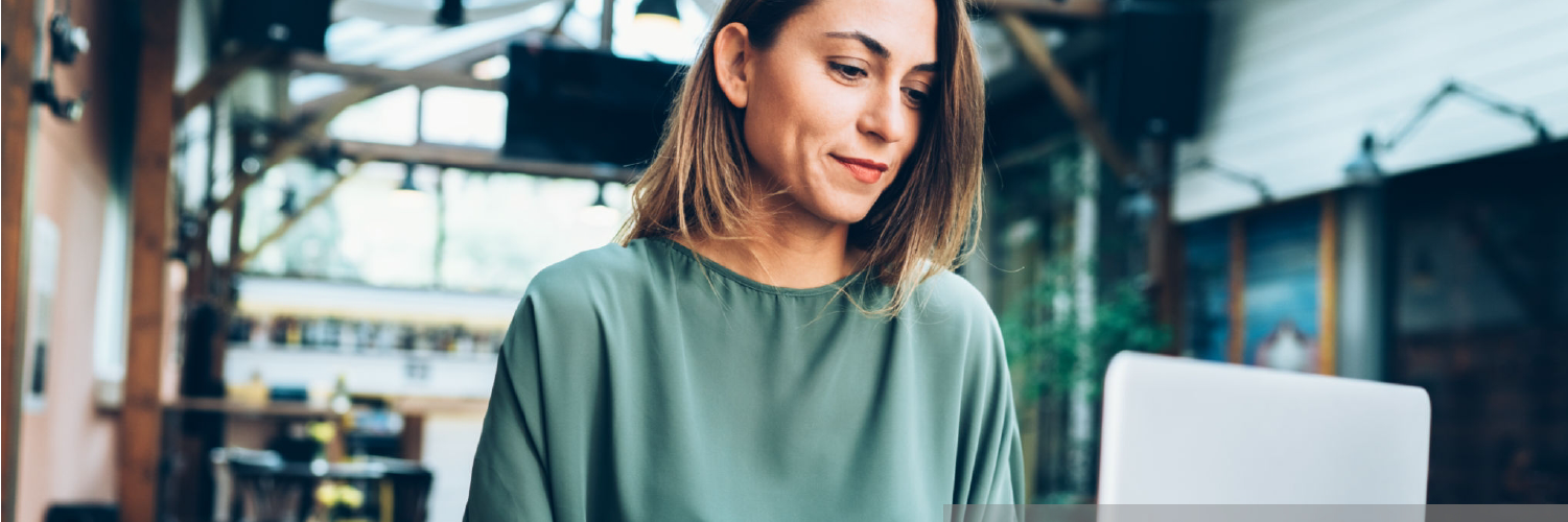 A woman looks at her computer.