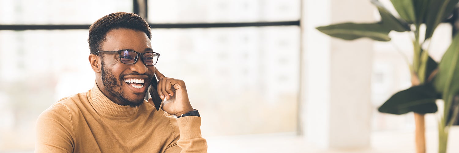 A man laughing on the phone.