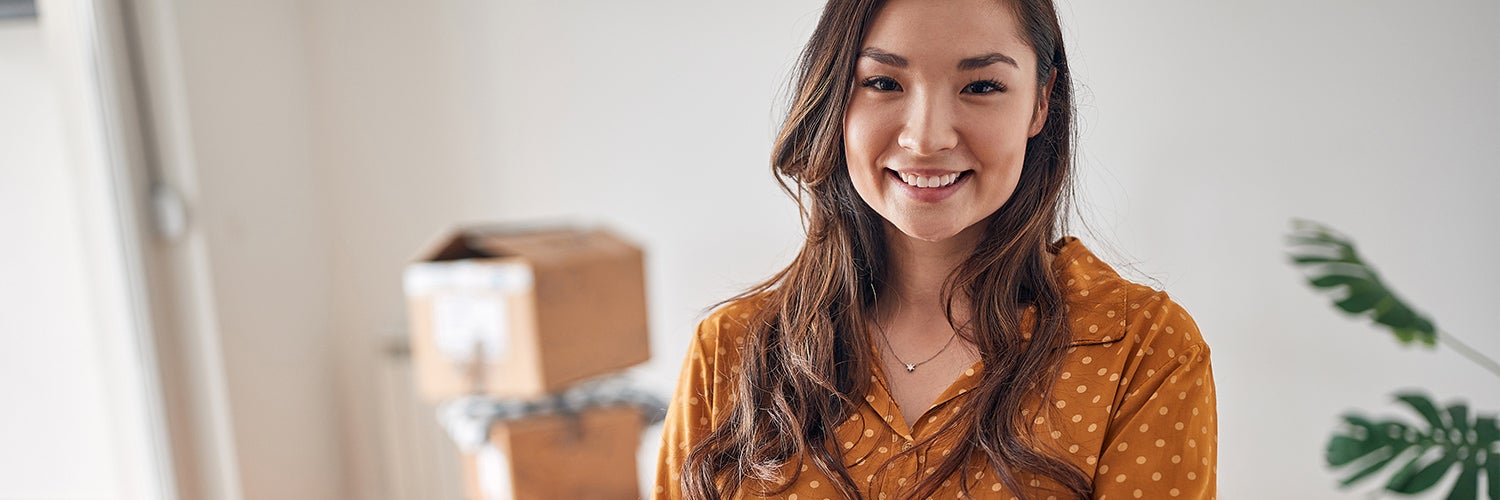 does getting rejected for a credit card affect your credit score? Woman in yellow stands in front of boxes