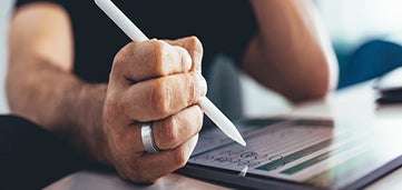person writing on tablet