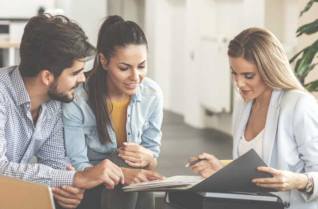 three people read documents